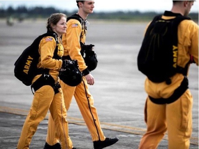 Master Sgt. Jennifer Davidson, Golden Knights demonstration team member, walks to a nearby aircraft before a jump in Homestead, Florida, Feb. 1, 2022.  The Golden Knights are a team of parachutists who serve as U.S. Army ambassadors to the...