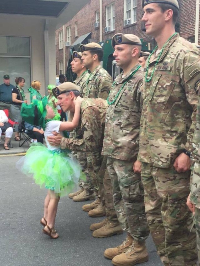 Sgt. 1st Class Christopher Celiz embraces his daughter Shannon as he stands with fellow Army Rangers during a St. Patrick&#39;s Day parade. 