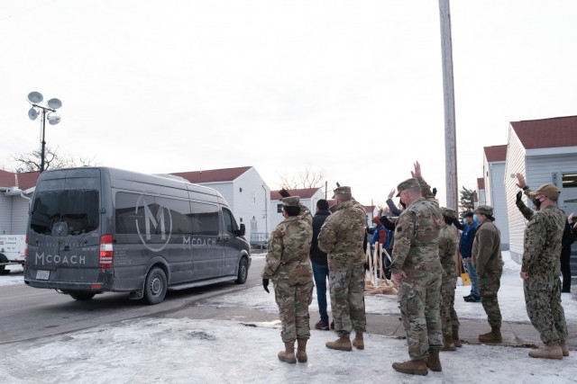 Task Force McCoy staff wave goodbye to the last family of Afghan guests as they depart Fort McCoy, Wis., on Feb. 15, 2022.  The Department of Defense, through U.S. Northern Command, and in support of the Department of Homeland Security, is providing transportation, temporary housing, medical screening, and general support for at least 50,000 Afghan guests at suitable facilities, in permanent or temporary structures, as quickly as possible. This initiative provides Afghan guests essential support at secure locations outside Afghanistan. (U.S. Army photo by Sgt. Robert P Wormley III, 50th Public Affairs Detachment)