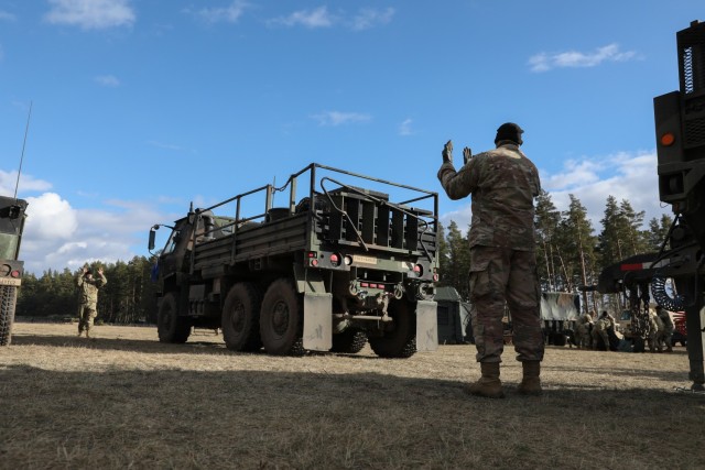 Soldiers assigned to 5th Battalion, 4th Air Defense Artillery Regiment, line up a military vehicle during exercise Saber Strike 22 at Bemowo Piskie Training Area, Poland, Feb. 25, 2022.