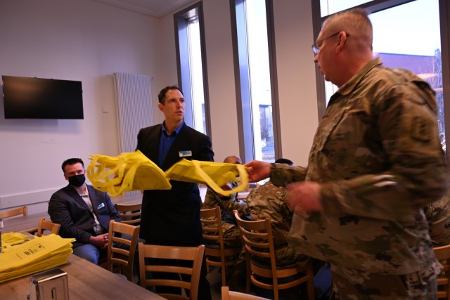 AER Officer Matt Diehls passes out AER campaign materials to unit representatives at the Kaiserslautern AER Campaign Kick-Off Breakfast, Feb. 23.