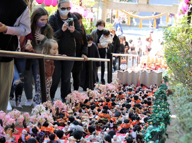 Participants of a walking tour held by Army Community Service admire "Hina" dolls as they go up the stairs to the Zama Shrine, Japan, March 1, 2022. Every year, shrines across Japan attract crowds by allowing parents to display intricate...
