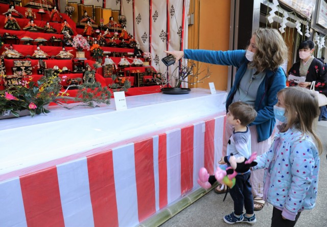 Debbie Derienzo, an Army spouse, shows her children, Paul and Eleanor, a "Hina" doll display during the Dolls Festival, or “Hinamatsuri,” at the Zama Shrine, Japan, March 1, 2022. Every year, shrines across Japan attract crowds by...