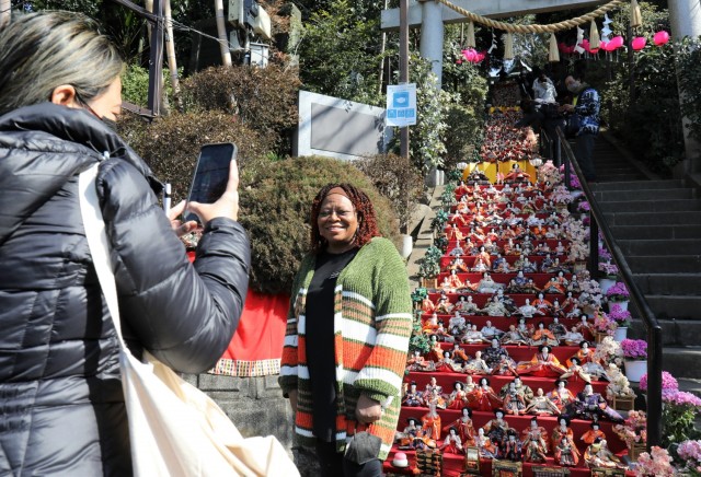 Linda Ferguson, a military and family life counselor at Camp Zama, poses for a photo in front of the steps leading up to the Zama Shrine in Japan, March 1, 2022. Army Community Service held a walking tour to the Shinto shrine for the Dolls...
