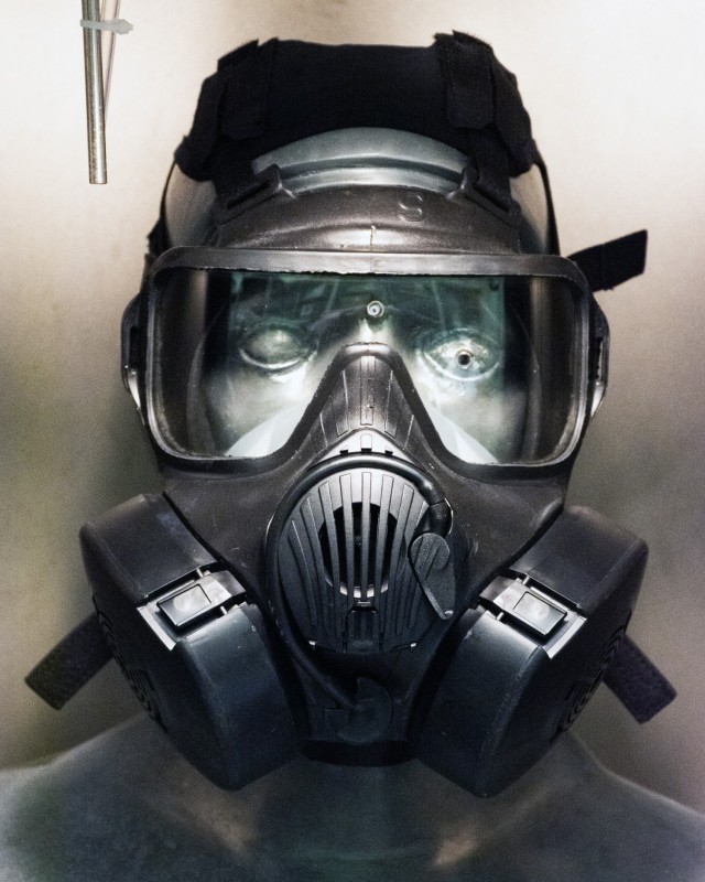 M50 gas mask affixed to SMARTMAN (Simulant Agent Resistance Test Mannikin) in small chamber, prior to challenging mask with Joint General Purpose Decontaminant for Hardened Military Equipment (JGPD HME). The test was conducted to learn whether the...