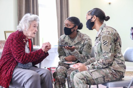 Annie Laura Bailey, one of the first women in Georgia to join the Women’s Army Auxiliary Corps in 1943, has a conversation with Spc. Dionna Smith, left and Spc. Ahmyra Hollis, right, both Soldiers assigned to Headquarters and Headquarters Battalion, 3rd Infantry Division, at Bethel Missionary Baptist Church in Statesboro, Georgia, Feb. 27, 2022. U.S. Army 3rd ID Soldiers celebrated Bailey as part of Women’s History Month, which recognizes the contributions women have made to the nation and the specific achievements they have made over the course of history.(U.S. Army photo by Pfc. Elsi Delgado)