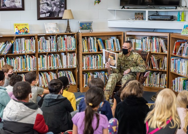 Maneuver Support Center of Excellence and Fort Leonard Wood Command Sgt. Maj. Randolph Delapena reads to students at Thayer Elementary School in celebration of Read Across America Day, which occurs every year in early March. More than 70 Fort Leonard Wood service members and Department of Defense civilians read to children in schools across mid-Missouri throughout the day. Since it was first celebrated in 1998, RAAD has provided a nationwide opportunity to encourage reading in children and teenagers.