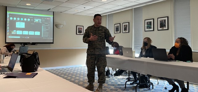 Joint Base Myer-Henderson Hall Deputy Commander Marine Lt. Col. Mark Paolicelli talks to Army Community Service employees and organization partners during the beginning stage of the standing up of the Emergency Family Assistance Center exercise...