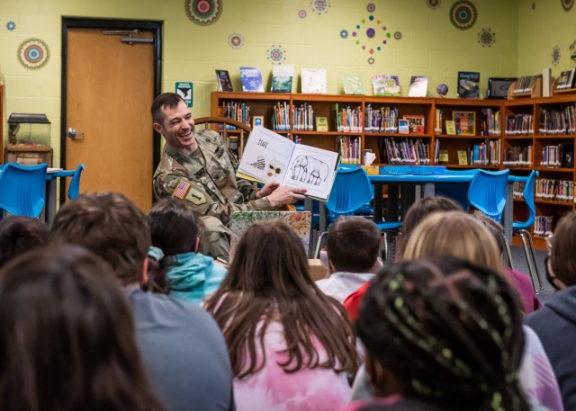 U.S. Army Garrison Fort Leonard Wood Commander Col. Jeff Paine reads to students at Wood Elementary School in celebration of Read Across America Day, which occurs every year in early March. More than 70 Fort Leonard Wood service members and Department of Defense civilians read to children in schools across mid-Missouri throughout the day. Since it was first celebrated in 1998, RAAD has provided a nationwide opportunity to encourage reading in children and teenagers.