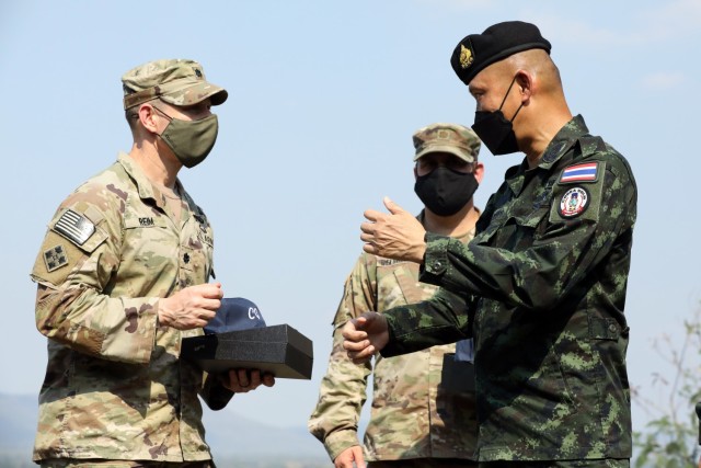 U.S. Army Lt. Col. Duke Reim (left) and Royal Thai Armed Forces Deputy Chief of Defense Forces Gen. Supachok Thawatperachai (right) exchange gifts after the conclusion of the dry fire exercise as part of Cobra Gold 2022 in the Lopburi Province of the Kingdom of Thailand, Feb. 26, 2022. CG 22 is the 41st iteration of the international training exercise that supports readiness and emphasizes coordination on civic action, humanitarian assistance, and disaster relief. From Feb. 22 through March 4, 2022, this annual event taking place at various locations throughout the Kingdom of Thailand increases the capability, capacity, and interoperability of partnered nations while simultaneously reinforcing our commitment to a free and open Indo-Pacific. (U.S. Army photo by Spc. Andrew Mendoza)