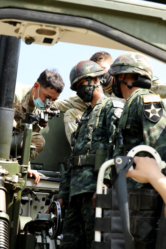 Army Spc. Derrek Miller, an infantryman with the 4th Battalion, 23rd Infantry Regiment, 2nd Stryker Brigade Combat Team, 7th Infantry Division, trains members of the 112th Infantry Regiment, Royal Thai Army, by inspecting their elevation...