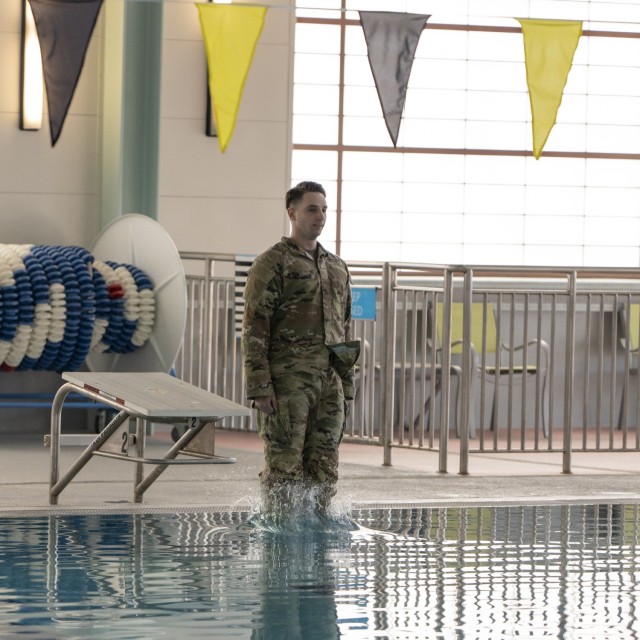 Sgt. James P. Parker III dives into the Camp Walker Aquatics Center pool before a reenlistment ceremony February 25, 2022. Parker said he wanted to reenlist at the aquatics center because he has found Army water training to be the most challenging.