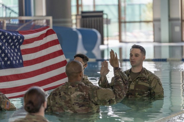 sergeant.  James P. Parker III takes the oath of enlistment at the Camp Walker Aquatics Center pool during a re-enlistment ceremony Feb. 25, 2022. Parker said he wanted to re-enlist at the aquatics center because he found that Army water training was the most difficult.