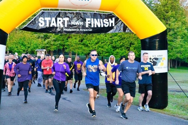 Runners participate in the Run in Their Shoes 5K to raise awareness for domestic violence during Domestic Violence Awareness Month in October 2021.
