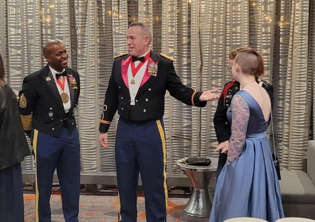 Command Sgt. Maj. Sean Rice, left, of the Security Assistance Command, and Grissom High JROTC instructor Jose Valentin, a retired colonel, greet cadets at the school’s JROTC military ball. 