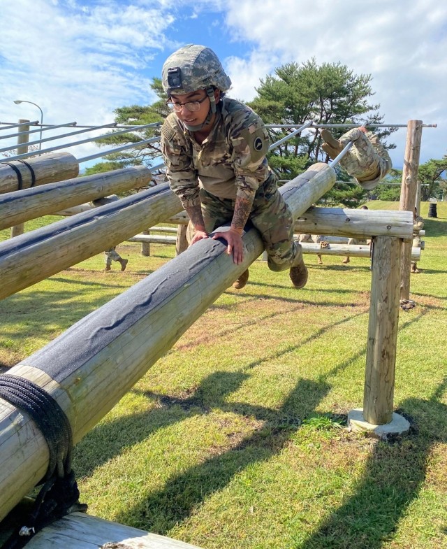 Spc. AnnaMarie Popoca, a transportation management coordinator assigned to 623rd Movement Control Team, 35th Combat Sustainment Support Battalion, maneuvers across a log as part of an obstacle course. Popoca, 22, chose to join the Army and follow in the footsteps of her father, who served more than 20 years as a motor transport operator.