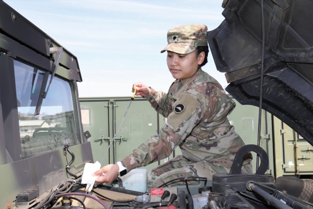 Spc. AnnaMarie Popoca, a transportation management coordinator assigned to 623rd Movement Control Team, 35th Combat Sustainment Support Battalion, checks the oil of her Humvee during routine maintenance at Sagami General Depot, Japan, March 7, 2022. Popoca, 22, chose to join the Army and follow in the footsteps of her father, who served more than 20 years as a motor transport operator. 