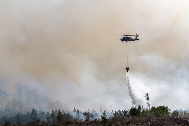 UH-60 Black Hawk and CH-47 Chinook helicopter crews from the Florida National Guard help battle wildfires in Bay County March 7, 2022. The Florida National Guard is working closely with state and local partners to contain the Chipola Complex fires...