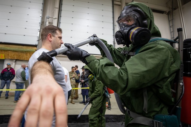Sgt. Keith Whittum, a Vermont National Guard Soldier with Company C, 3rd Battalion, 172nd Infantry Regiment, removes simulated radioactive particles using a vacuum on March 1, as part of a dry-decontamination technologies operational assessment during Exercise Arctic Eagle-Patriot 22 at the Anchorage Fire Training Center in Anchorage, Alaska. Fort Leonard Wood personnel from the Maneuver Support Center of Excellence Homeland Defense Civil Support Office facilitated the assessment on the technologies and how they can apply to chemical, biological, radiological and nuclear victim care in cold-weather environments. 