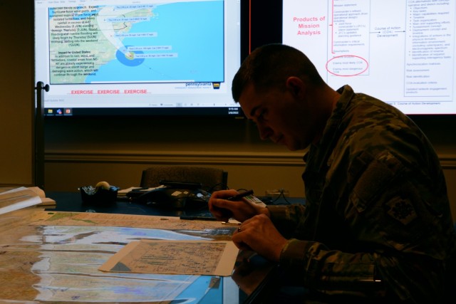 Capt. Brandon Sweeney, current operations officer, Pennsylvania National Guard, marks unit locations on a map of Pennsylvania during a staff training course March 8, 2022. The trial course, hosted by U.S. Northern Command, trained staff on...