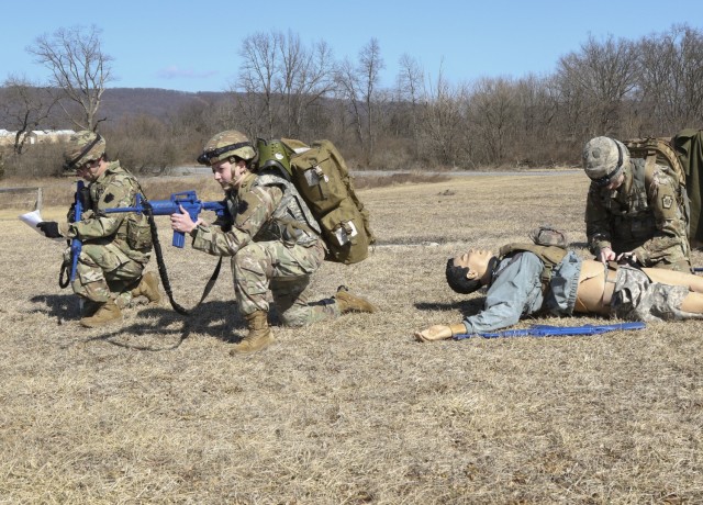 Combat medics with the Pennsylvania National Guard provide security while another renders tactical field care to a simulated casualty as part of the TC8-800 medic sustainment course March 2 at Fort Indiantown Gap, Pennsylvania. The course enabled...