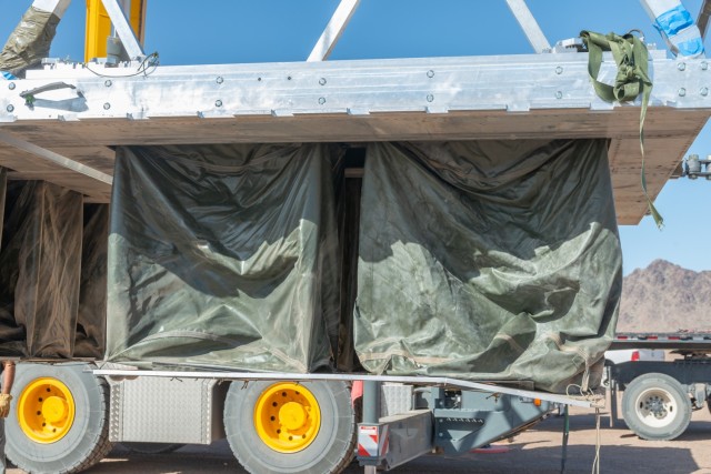A vehicle is loaded onto the ATAX platform with an under-mounted airbag system. The ATAX airdrop system has significant advantages over traditional systems because it uses reusable airbags to soften the impact when the vehicle lands. Traditional airdrop systems use multiple layers of stacked paper honeycomb that is three inches thick to soften the landing. The paper honeycomb, which is crushed by the impact, is left in the field and can take up to an hour or more for Soldiers to free the vehicle from the paper honeycomb.