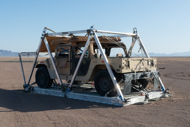 The ATAX airdrop system is modular and consists of eight-foot platforms connected by hinges. It can be adapted to different lengths, typically between 8 and 32 feet, and it is surrounded by a self-contained structure where the parachutes are mounted and attached. The vehicle is loaded onto the ATAX platform with an under-mounted airbag system.