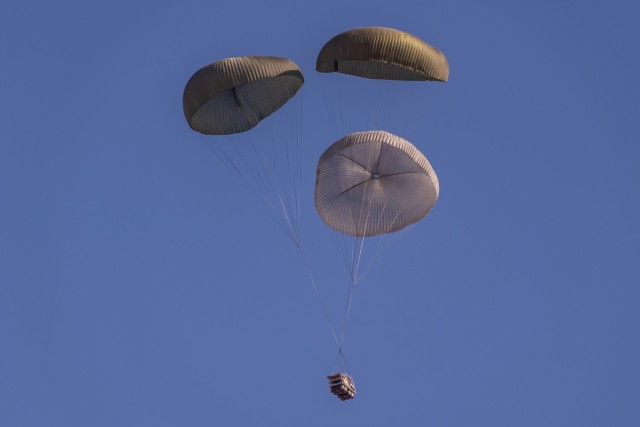 Parachutes are mounted and attached to a self-contained structure that surrounds the ATAX airdrop system. The ATAX system is modular and consists of eight-foot platforms connected by hinges. The platform can be adapted to different lengths, typically between 8 and 32 feet. 