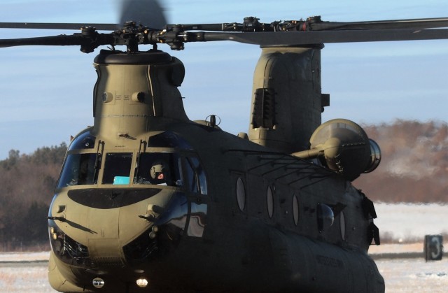 Crew guides CH-47 Chinook for sling-load training support at Fort McCoy