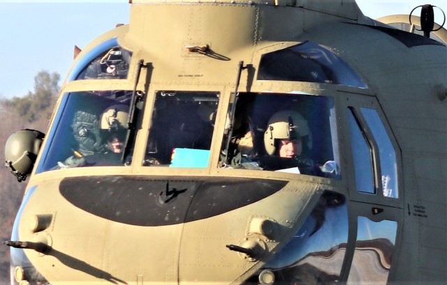 Crew guides CH-47 Chinook for sling-load training support at Fort McCoy