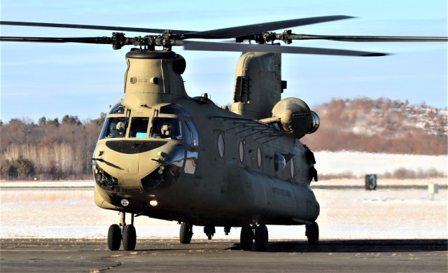 Crew guides CH-47 Chinook for sling-load training support at Fort McCoy