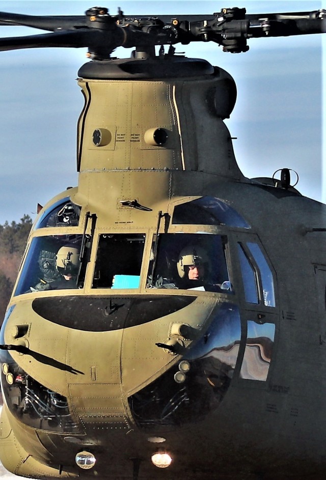 Crew guides CH-47 Chinook for sling-load training support at Fort McCoy