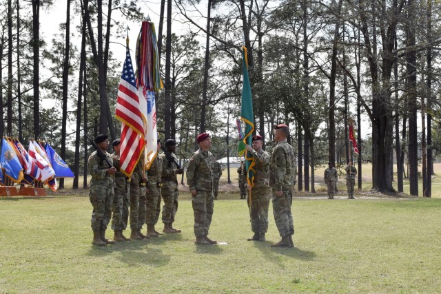 Command Sgt. Maj. Michael C. Henry, outgoing post command sergeant major, prepares to pass the colors to Brig. Gen. David S. Doyle, JRTC and Fort Polk commanding general, signifying his relinquishment of responsibility at a ceremony held March 3...