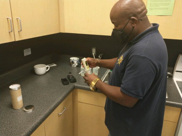Nathaniel Williams, Aerostar Water Compliance Manager, samples water for pH prior to collecting a bacteriological sample.  MEDDAC, O&M, and the Environmental Division work together to collect samples on Fort Stewart and HAAF.