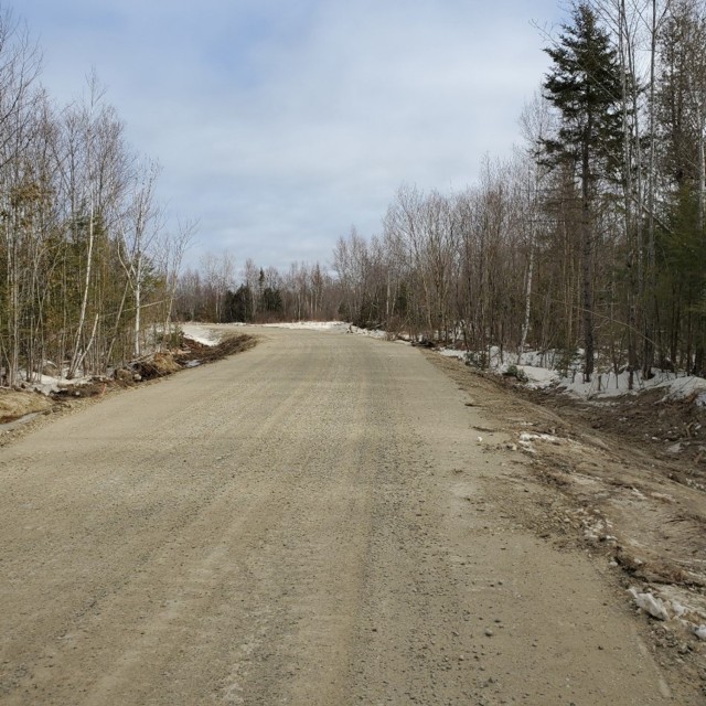 The same road after development by the MEARNG. MEARNG’s new roads support the training mission and the watershed by raising the roads and restoring natural drainage patterns.