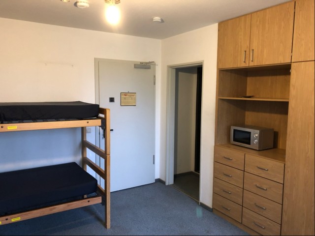 A bunk bed and a microwave in a hotel