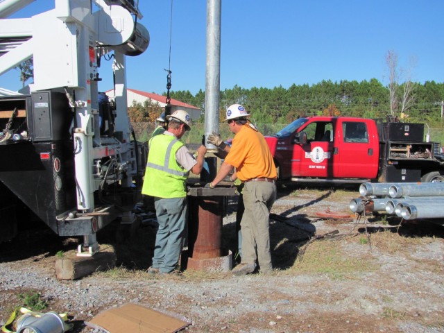 The Lower Floridan aquifer well being drilled at HAAF.  Workers shown here during the installation of a pipe which is attached to the submersible pump.  This well was drilled to ~1,100 feet. 