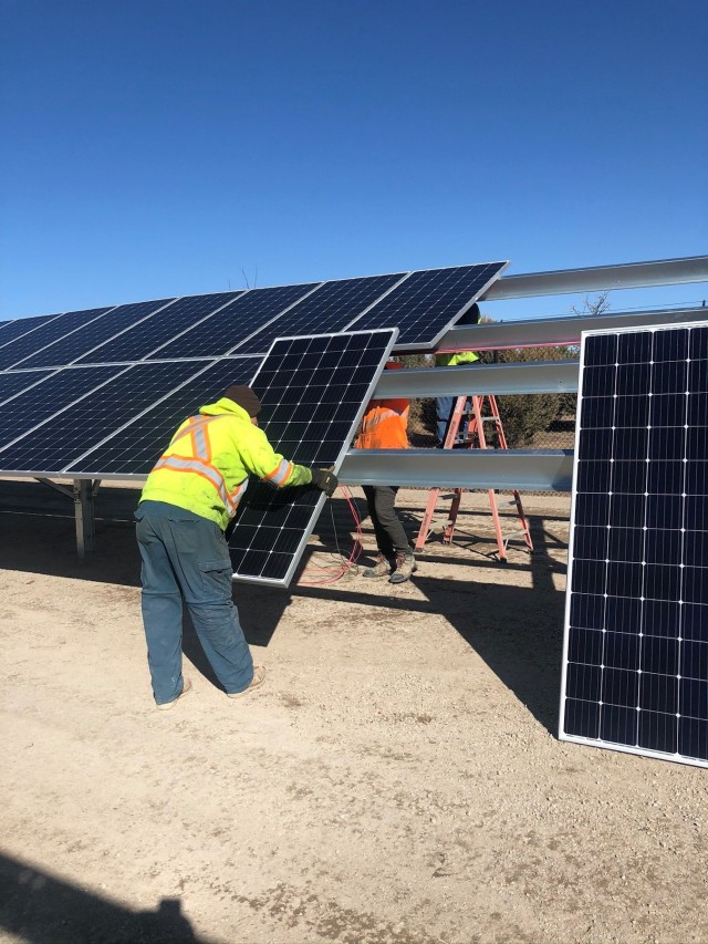 A solar installer technician replaces a solar panel on Colorado’s Fort Lupton Readiness Center, July 2020. The Colorado Department of Public Health and Environment’s Supplemental Environmental Program funded the 150kW Photovoltaic Solar array at the Fort Lupton Readiness Center in Colorado.  Electricity generated by the solar panels will offset 100% of the facility needs which makes the Readiness Center Net-Zero electric.