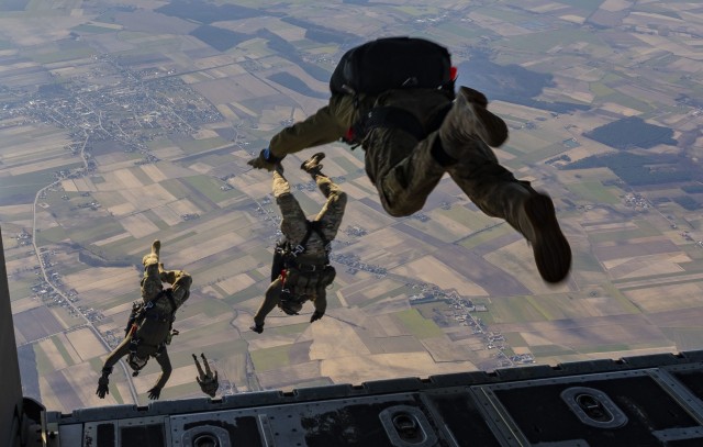 Polish special forces operators execute a military free fall jump from a U.S. Air Force MC-130J Commando II assigned to the 352d Special Operations Wing over Poland, March 11, 2022.