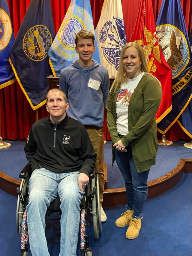 Connor Briest with his father, Sgt. Corey Briest, and mother, Jenny, as he joins the South Dakota Army National Guard at the Military Entrance Processing Station in Sioux Falls, S.D., March 11, 2022. (Photo by South Dakota Army National Guard)