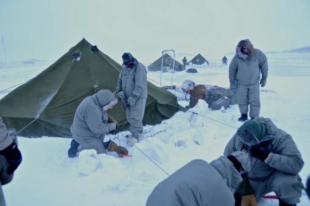 Soldiers from the 86th Infantry Brigade Combat Team (Mountain), Vermont Army National Guard, set up their bivouac site in the Arctic Circle, March 3, 2014 during Guerrier Nordique extreme cold-weather training in Canada.  (U.S. Army National Guard Photo by Sgt. 1st Class Jason Alvarez)