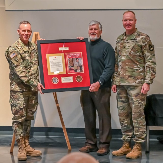 Army AMD leaders present Dr. Foust with a plaque commemorating his contributions 