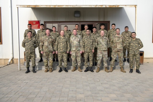 Members of the Oklahoma National Guard and the Azerbaijan Peacekeeping Brigade gather for a group photo at the conclusion of a joint partnership strategic planning and unit training management event March 3, 2022, in Baku, Azerbaijan. (U.S. Air Force photo by Tech. Sgt. Brigette Waltermire)