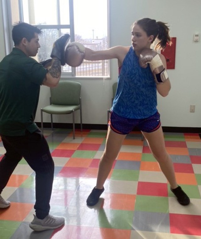Charlotte Patterson, right, participates in a boxing training session at the Camp Zama Youth Center, Japan. Patterson, who serves as president of the student body executive board at Zama Middle High School, started the sport after she stopped running due to a hip injury.