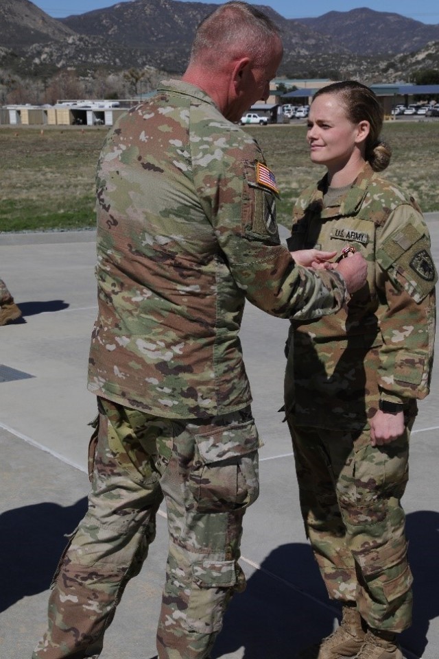 Nebraska Army National Guard Sgt. Brittany West is awarded the meritorious service medal at a ceremony conducted by Company A, 1st Battalion, 376th Aviation Regiment at Campo Border Patrol Station in Pine Valley, California, March 15, 2022. West,...