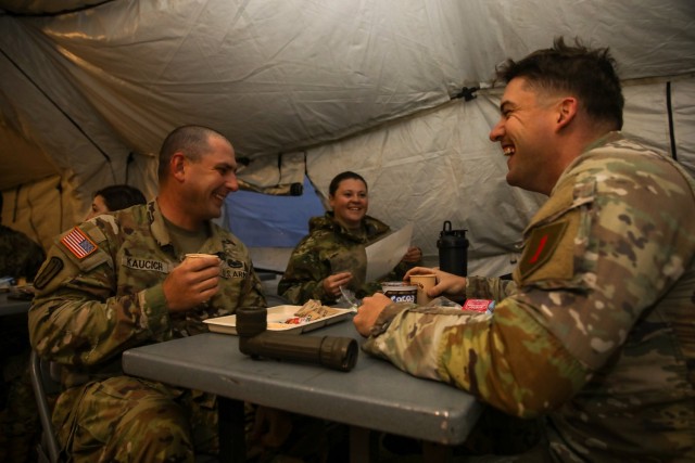 Soldiers from the 1st Sustainment Brigade, 1st Infantry Division, enjoy the food service being provided by the 511th QMC field-feeding team during the 54th Annual Philip A. Connelly Awards Program culinary competition on March 22nd, 2022, at Fort Riley, Kansas.