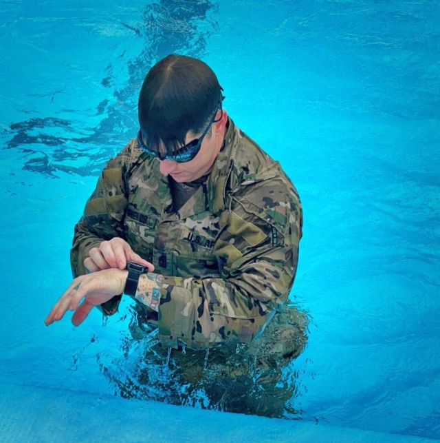 U.S. Army 1st Sgt. Wesley Shields checks his time after completing a round of laps in the Caserma Ederle pool, in Vicenza, Italy, before continuing another lap on Feb. 10, 2022. Shields was among several paratroopers training for Army competitions...
