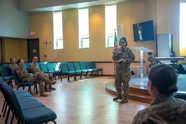 Chaplain (Lt. Col.) Jennifer Cooper, senior account manager for the Chaplain Corps, speaks about Chaplain (Maj.) Tanya Bindernagel, assigned to the 10th Mountain Division Sustainment Brigade, 10th Mountain Division, during Bindernagel’s promotion ceremony, March 14, 2022, on Fort Drum, New York. (U.S. Army photo by Sgt. 1st Class Neysa Canfield, 10th MDSB Public Affairs Office)