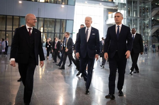 President Joe Biden and NATO Secretary General Jens Stoltenberg walk through NATO headquarters in Brussels, March 24, 2022.