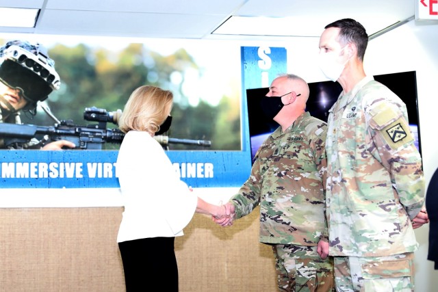 Secretary of the Army Hon. Christine Wormuth presents a challenge coin to Sgt. Maj. Greg Brobst from CAC-Headquarters in recognition of excellence during her visit to the Combined Arms Center-Training Innovation Facility at Fort Leavenworth, Kan. March 21, 2022. Also included in the group were Dr. Marilyn Willis-Grider from Mission Command Center of Excellence, Lt. Col. Eric Glassman from Mission Command Training Program and Lt. Col. Kyle Yanowski from Combined Arms Center-Training. Curt Pangracs from Army University was unable to attend and his coin was accepted by his supervisor. Photo by Tisha Swart-Entwistle, Combined Arms Center-Public Affairs.